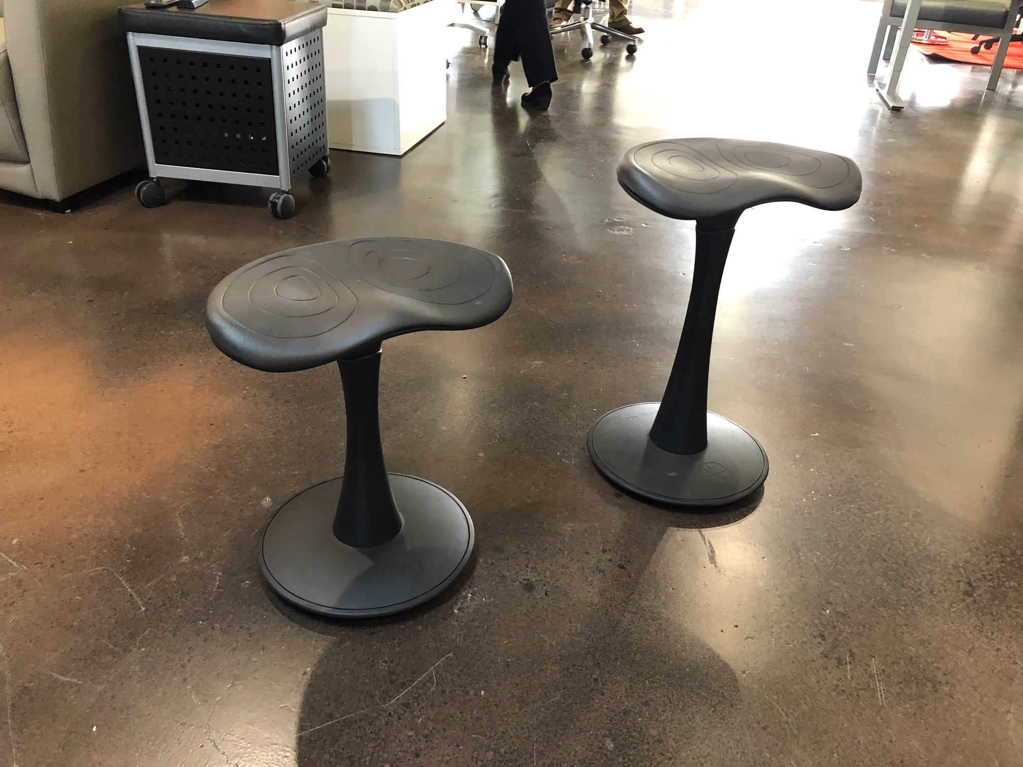 Black and Red Stools at white desk